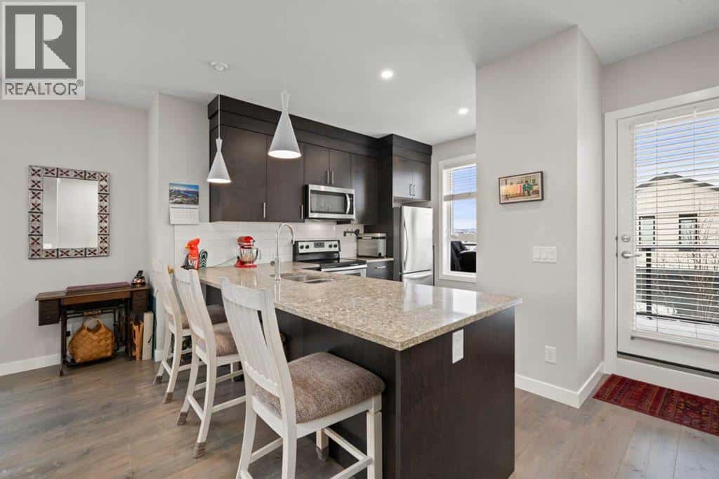 512 Drake Landing Wynd — Okotoks, Alberta - Photo 4 of 39